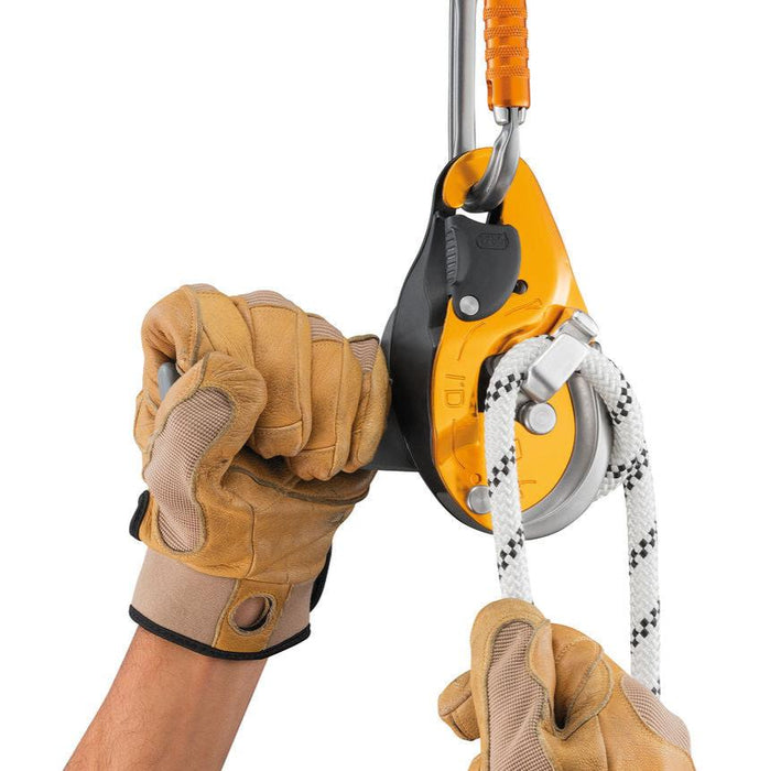 Petzl ID EVAC Descender in use showing the ergonomic handle which allows unlocking the rope and comfortably controlling the descent.