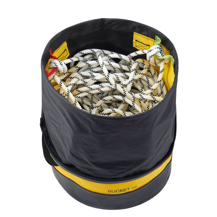 Petzl Bucket 45 Litre bag in Yellow open showing the bag open with a white rope inside. This bag can store up to 185 meters of 11 mm diameter rope.