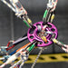 Purple DMM Rigging Hub used as a centralised anchor point, securely connecting multiple ropes, slings, and carabiners in a complex rigging setup