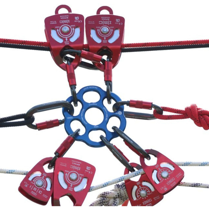 Close-up of a blue ISC HALO Rigging Plate integrated into a complex rigging system with multiple ropes and red pulleys.