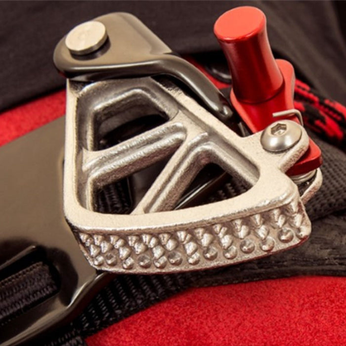 Close-up of the ISC Stryder Left Foot Ascender cam mechanism, highlighting the stainless steel construction, textured grip, and red locking lever for secure rope engagement.