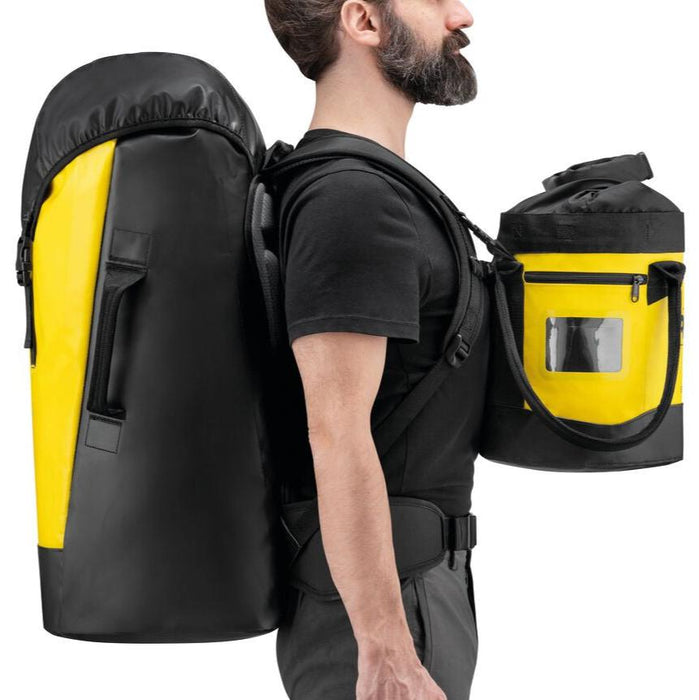 Professional wearing Transport 60 backpack and Bucket rope bag using loops on the Petzl Transport 60 shoulder straps to attach a Petzl BUCKET rope bag to carry in front.