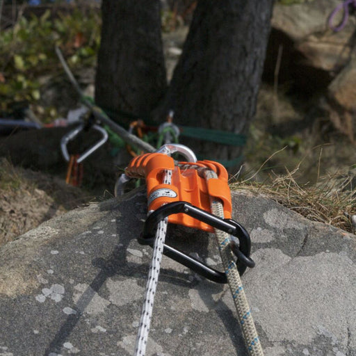 SMC Rope Tracker protecting ropes during a rigging operation, placed securely over a rocky edge with carabiners and ropes in use.