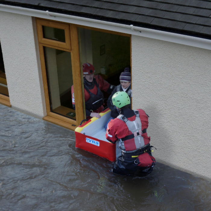 rescue responders evacuating person from flooder home in WRS evacuation sled