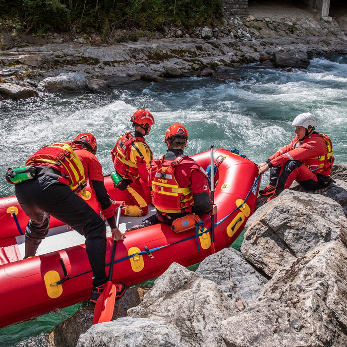 Rescue responders donning WRS rescue wraps and WRS technical helmets about to go paddling in whitewater on WRS mega seld