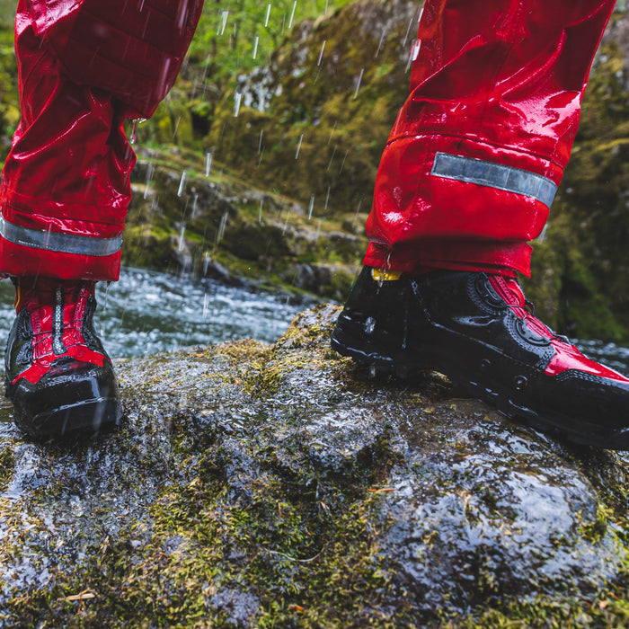 Person showing waterproof WRS Rescue Boots in the rain  under drysuit 