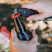 Hand model demonstrating bottle opening feature of Gear Aid Akua River Knife 